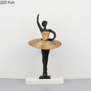Elegant black and gold ballerina sculpture with woven golden tutu on white marble base for bedroom decor