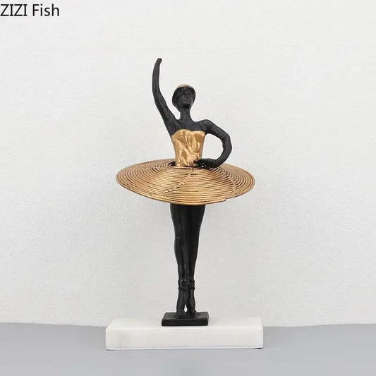 Elegant black and gold ballerina sculpture with woven golden tutu on white marble base for bedroom decor