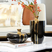 Elegant black gold ceramic vase set with glossy finish featuring tall slender and short rounded vases for luxury decor