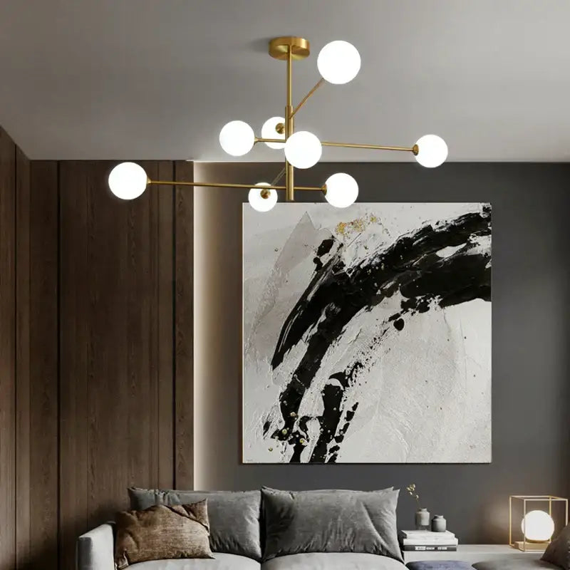 Elegant black gold chandelier with multiple spherical white glass bulbs for living room lighting