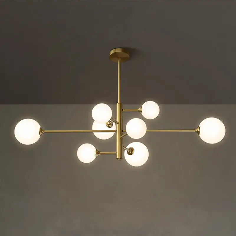 Elegant black gold glass ball chandelier featuring modern brass frame and frosted glass globe bulbs for living room lighting