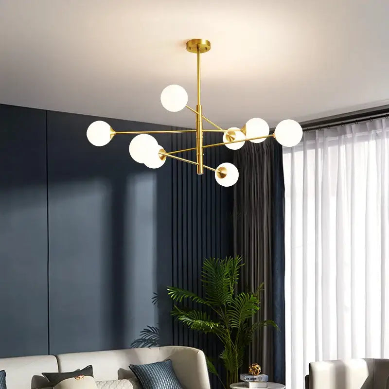 Elegant black gold chandelier with multiple spherical white glass shades for living room lighting
