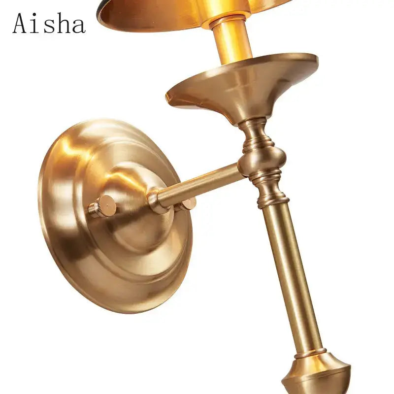 Brass-finished aisha wall sconce with fluted details and curved arm in decorbites black gold wall lamp for bedroom decor