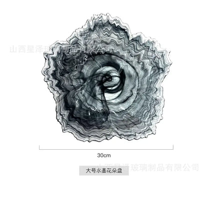 A large circular glass plate with swirling black and white inkblot design for elegant flower glass decorbites use