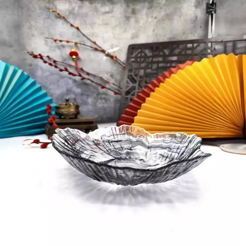 Translucent iridescent glass plate with wavy leaf rim and intricate swirls for decorbites elegant flower glass display