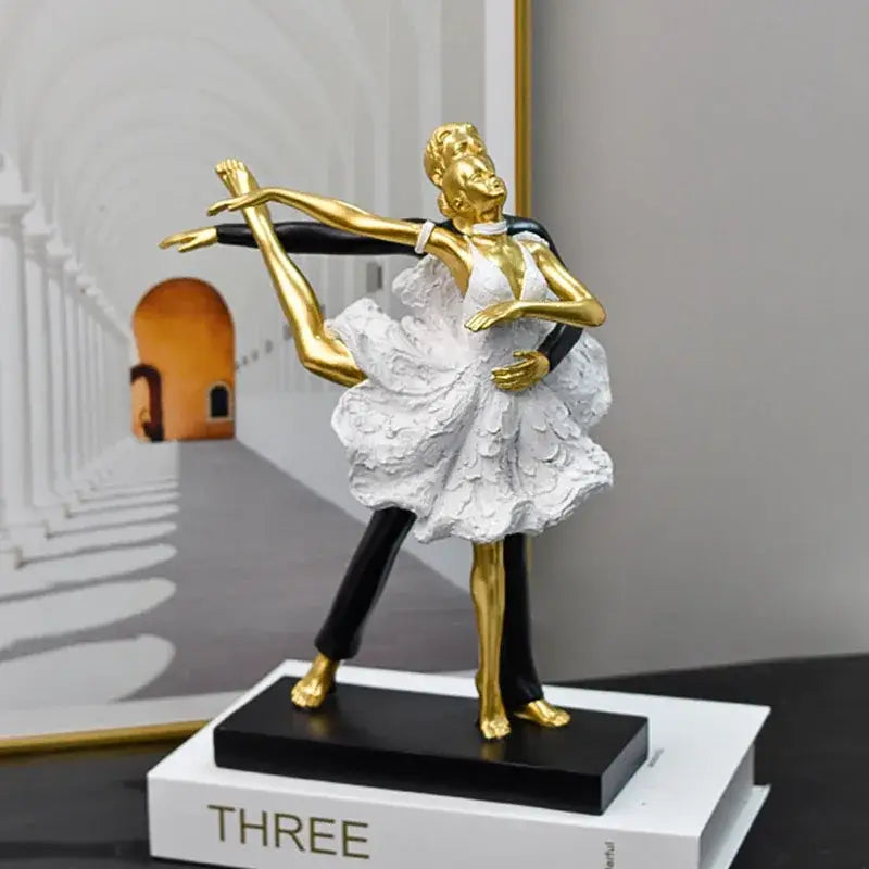 Elegant black and white ballet dance girl double statue featuring a golden and white figurine with intricate dress details on a black base
