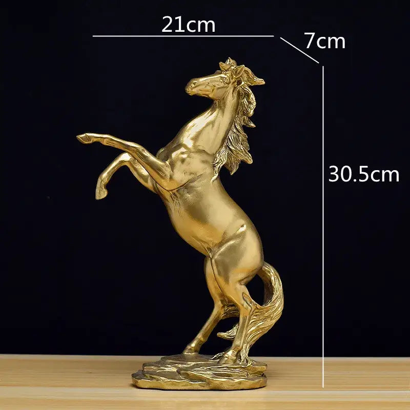 Elegant black and white decorbites golden horse animal sculpture with detailed mane and tail on a textured base
