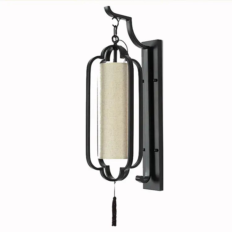 Elegant black wrought iron wall sconce lamp with beige linen shade and black tassel ideal for bedroom lighting