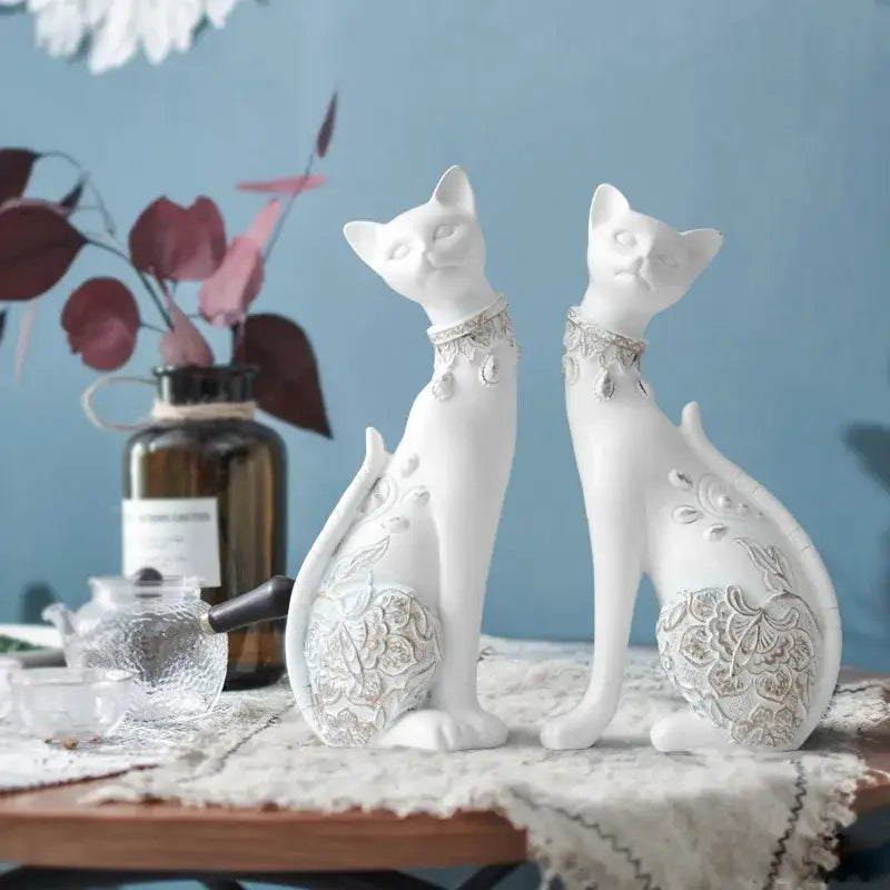 Two elegant white ceramic decorbites cat statues with silver lace patterns and chokers for living room decor