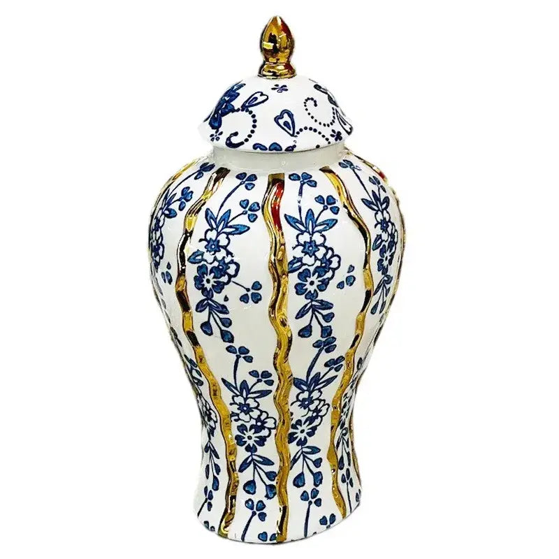 Elegant blue glazed ceramic ginger jar with white base, blue floral patterns, gold accents, and a matching lid finial