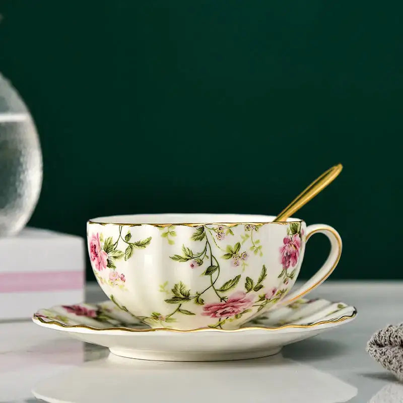 Elegant blue and pink floral porcelain tea cup set featuring a delicate white porcelain tea cup with gold accents