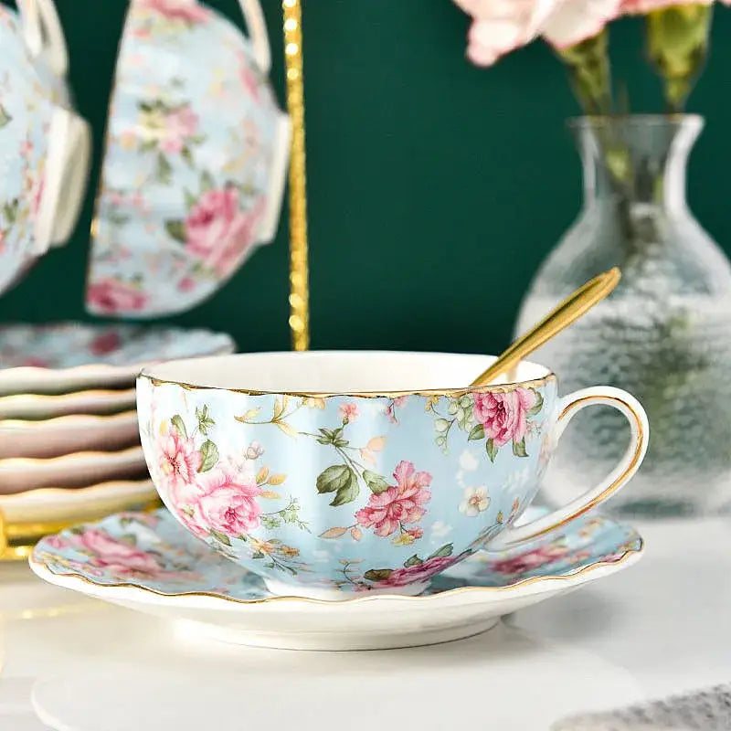 Elegant light blue porcelain tea cup set with pink rose floral pattern and gold trim for dining room use