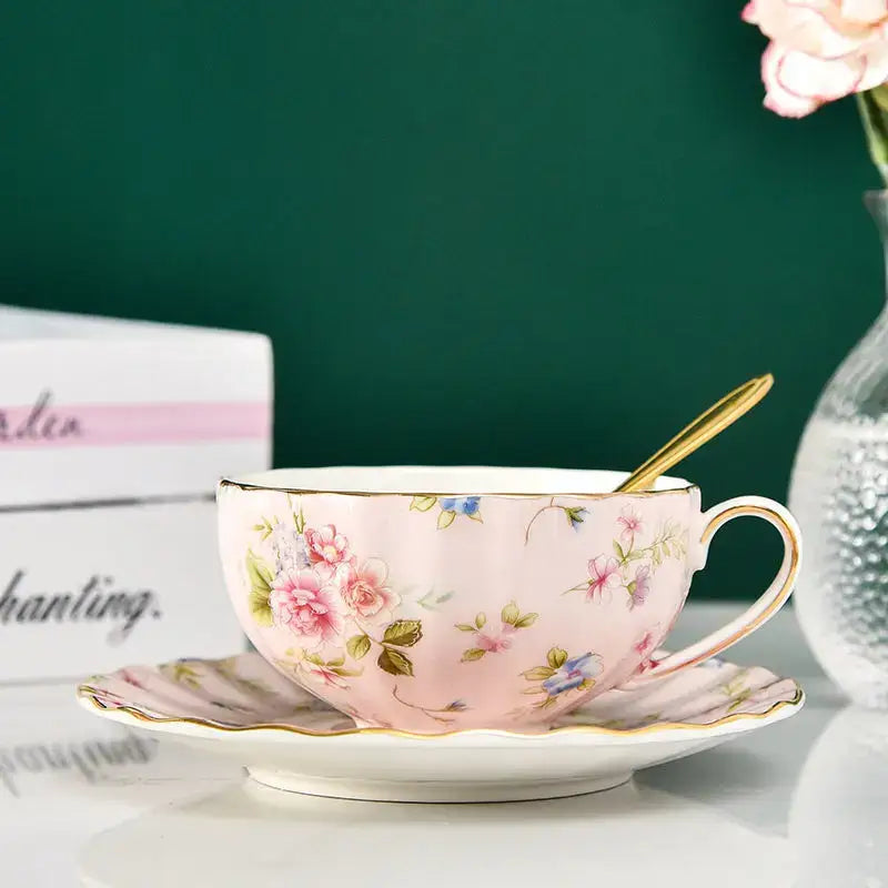 Elegant blue and pink floral porcelain tea cup set featuring a pink floral porcelain tea cup with gold trim and matching saucer