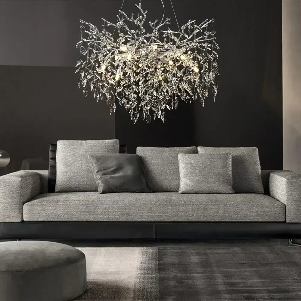 A modern silver-toned pendant light with intricate metallic frame and dangling crystal leaves for dining room decorbites crystal suspension