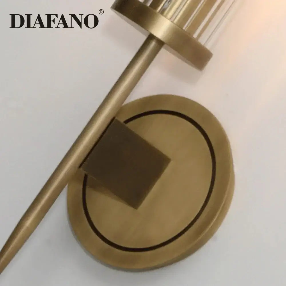 Brass-finished wall sconce with cylindrical black glass shade and circular backplate ideal for decorbites copper wall sconce decor