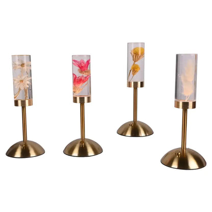Four elegant gold-toned decorbites eternal flower desk lamps with clear glass tubes and vibrant preserved flowers