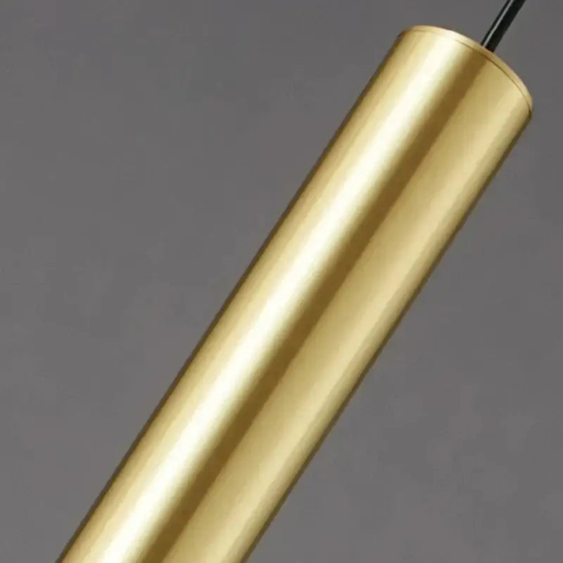 A sleek, cylindrical brass pendant light with polished metallic finish from decorbites elegant brass pendant for dining room decor
