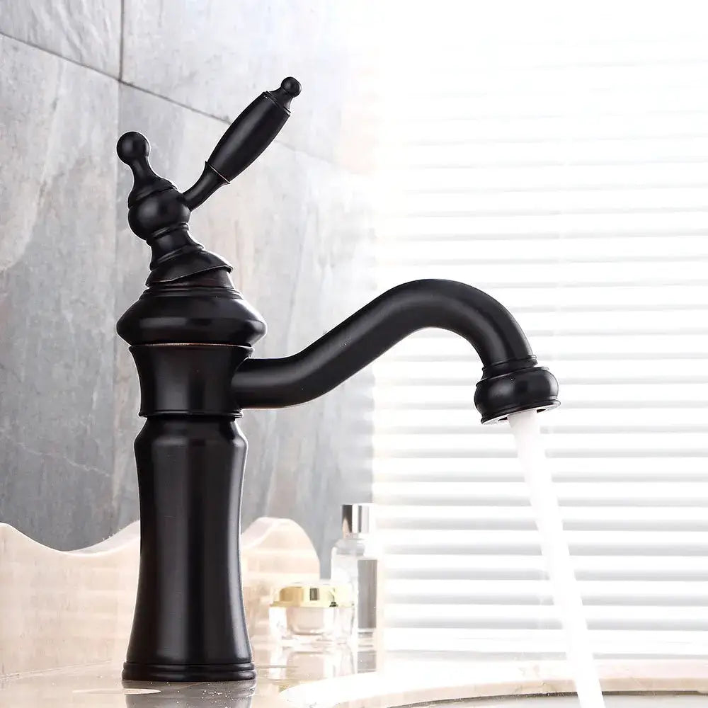 Black matte vintage-style basin faucet with ornate handle and curved spout contrasting decorbites brushed nickel finish