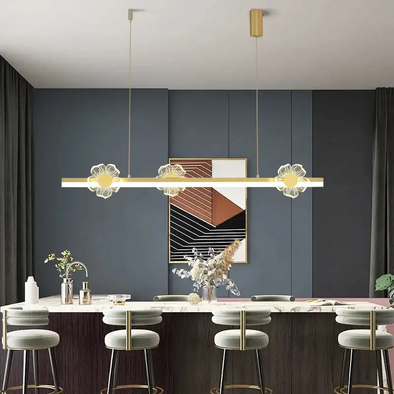 Modern gold-toned linear pendant light with three illuminated floral designs in decorbites elegant butterfly chandelier for dining room