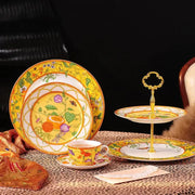 Yellow porcelain dessert stand with gold accents and floral design from elegant butterfly kitchen tableware set