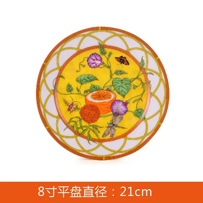 A vibrant yellow porcelain butterfly kitchen tableware plate with purple flowers and orange geometric border design