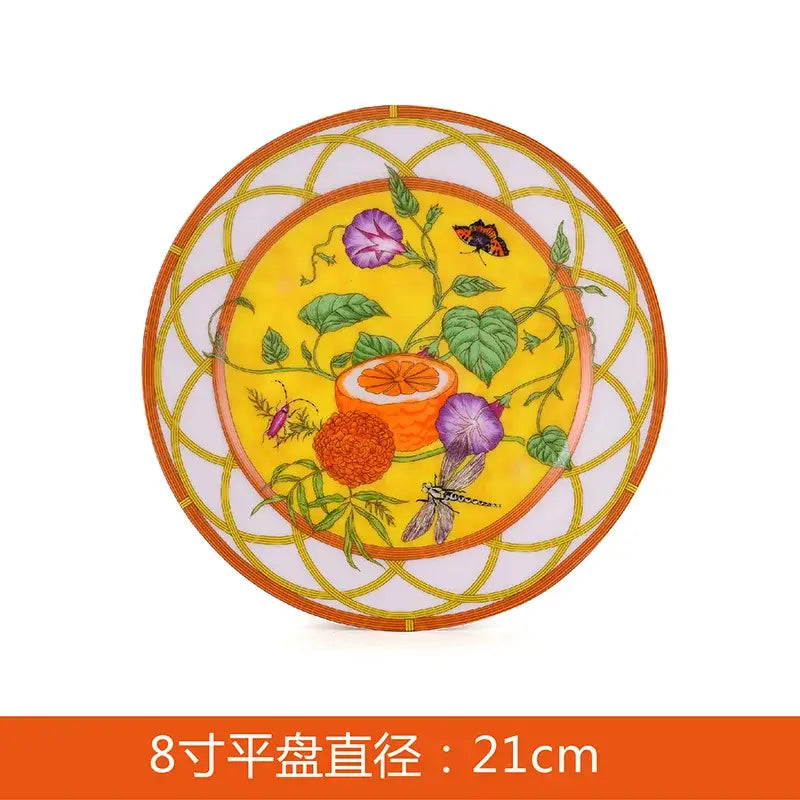 A vibrant yellow porcelain butterfly kitchen tableware plate with purple flowers and orange geometric border design
