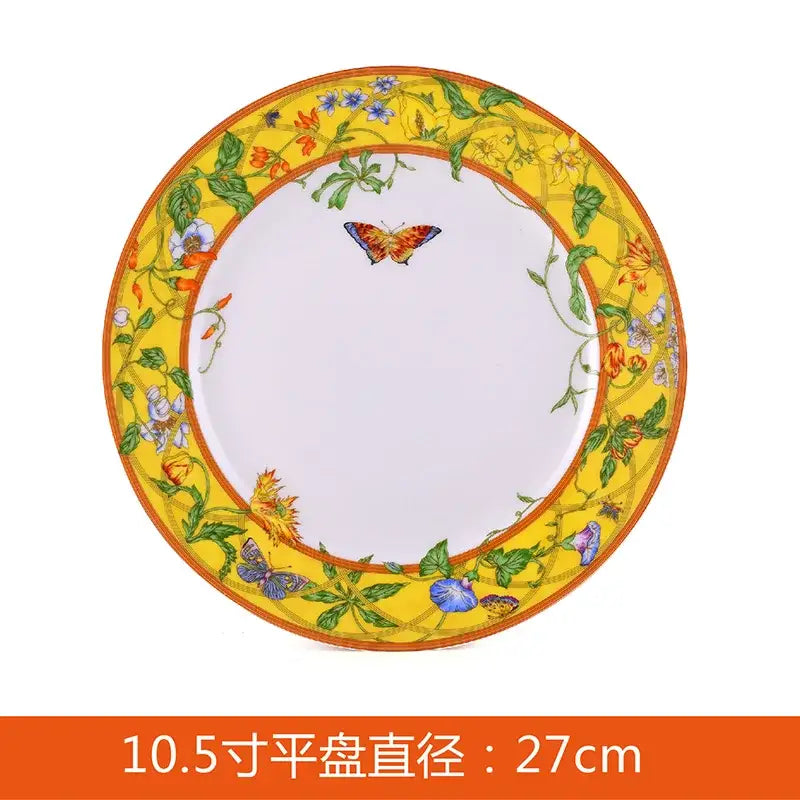 A vibrant yellow porcelain butterfly kitchen tableware set plate with floral rim and central orange and blue butterfly design