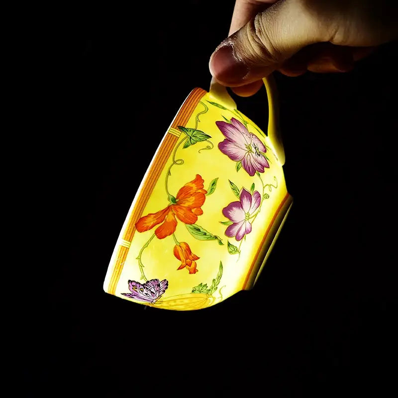 A vibrant yellow porcelain butterfly kitchen tableware teacup with hand-painted floral and butterfly motifs