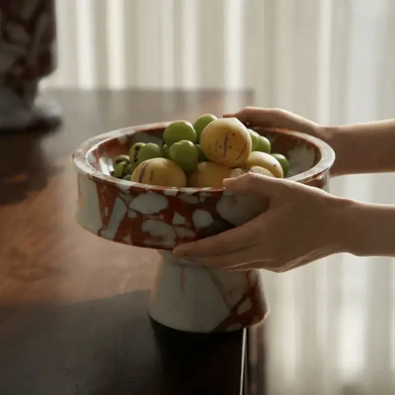 Elegant calacatta red marble vase ceramic pedestal bowl with white rust pattern holding green and yellow fruits decorbites calacatta red decor