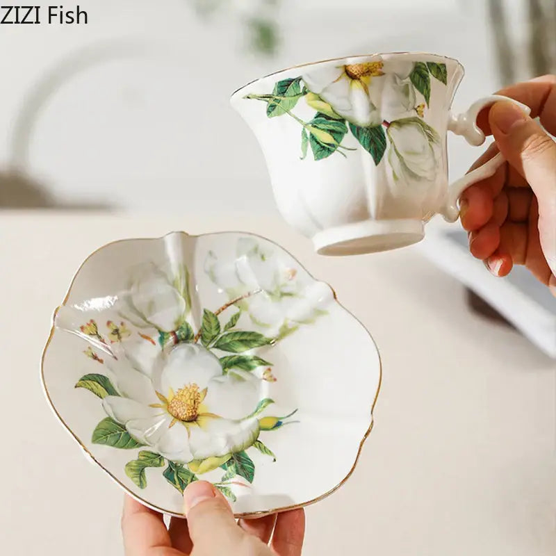 White porcelain camellia porcelain cup and saucer set with delicate floral design and gold-trimmed edges by decorbites camellia