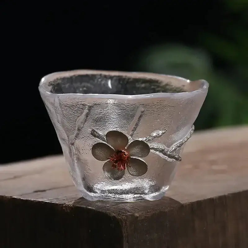 Elegant carved tin glass tea cup set featuring a translucent frosted cup with silver cherry blossom design