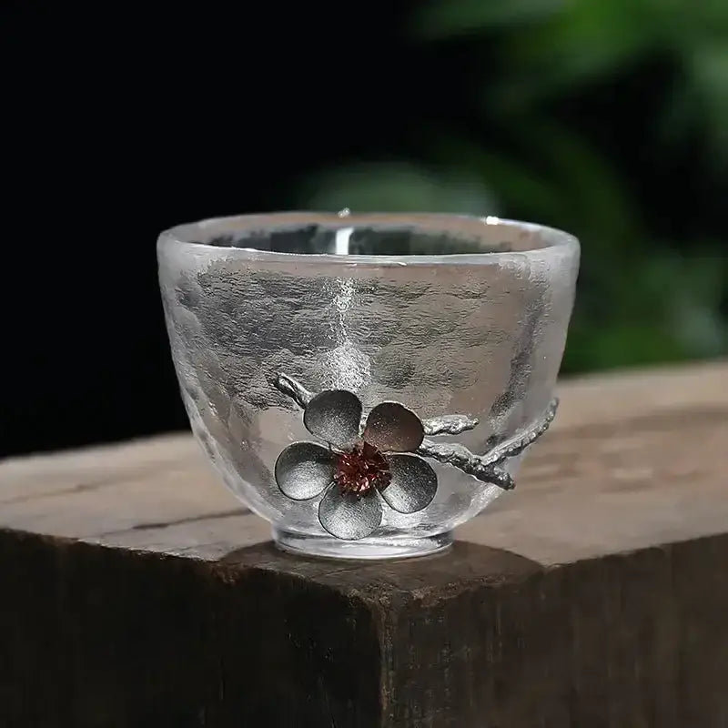 Elegant carved tin glass tea cup set with clear textured glass and silver cherry blossom accent for dining room use