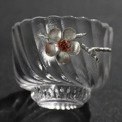 Elegant carved tin glass tea cup set featuring a clear ribbed glass tea cup with silver flower and copper accent