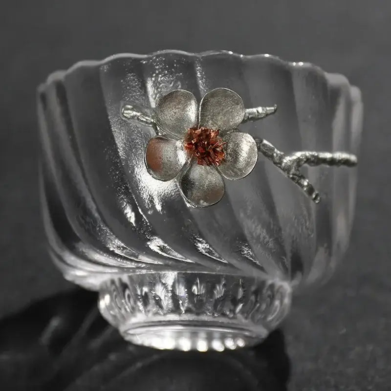 Elegant carved tin glass tea cup set featuring a clear ribbed glass tea cup with silver flower and copper accent