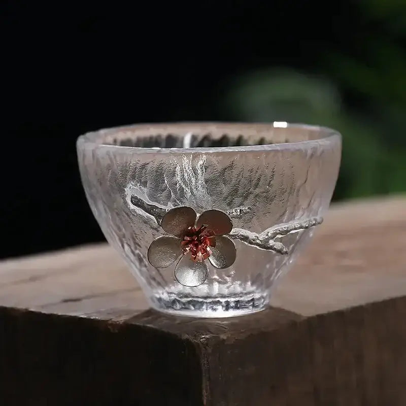 Elegant carved tin glass tea cup set featuring a clear hammered glass cup with ornate silver cherry blossom design and red center