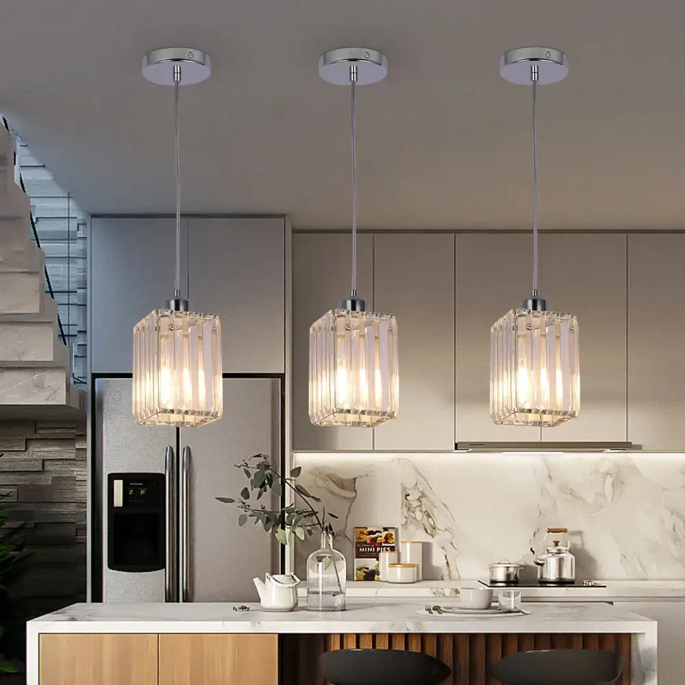 Three modern pendant lights with clear decorbites crystal glass shades and chrome fixtures for dining room chandelier