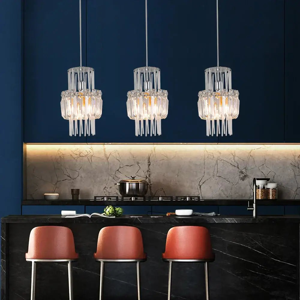 Three identical decorbites crystal glass ceiling chandeliers with cascading clear prisms in a modern kitchen decor