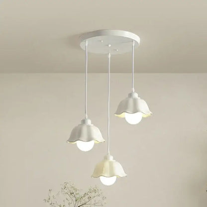 Elegant cream led chandelier with three bell-shaped white pendant shades and circular base for dining room decorbites elegant cream