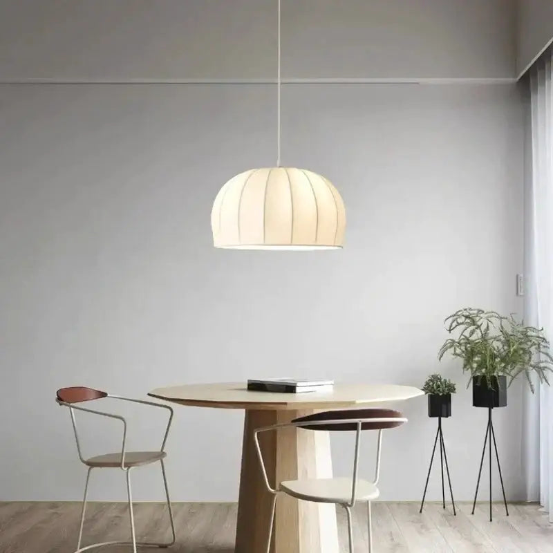 Cream-colored pleated decorbites elegant silk pendant light with soft diffused glow for dining room decor