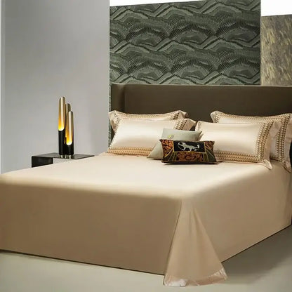 Cream-colored satin bed sheet with elegant gold embroidery edges in decorbites 1200tc egyptian cotton bedding set