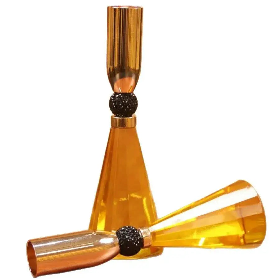 Elegant crystal and gold candle holder set featuring golden amber glass with black beads and metallic gold rims for dining decor