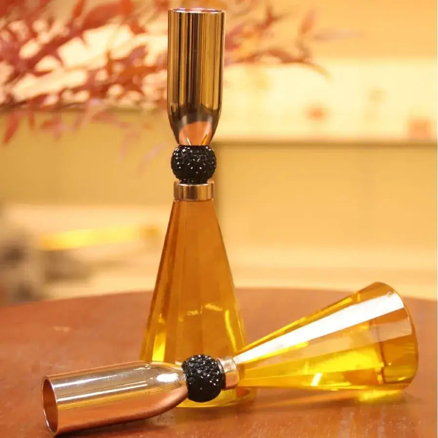 Elegant crystal and gold candle holder set featuring a golden acrylic holder with black beaded accent and metallic cap