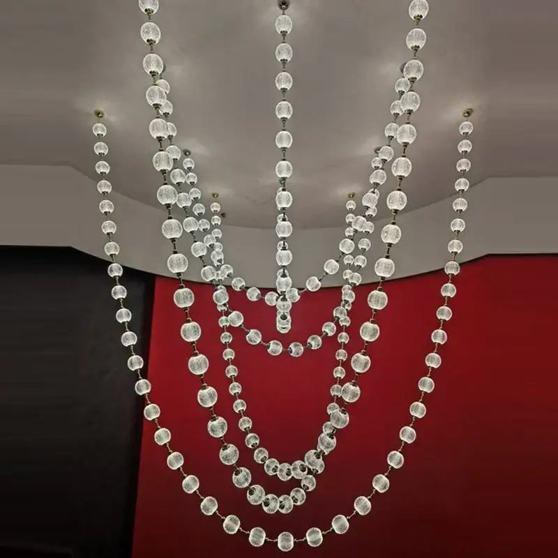 A modern staircase chandelier with clear faceted glass spheres and gold accents from decorbites elegant pendant lights