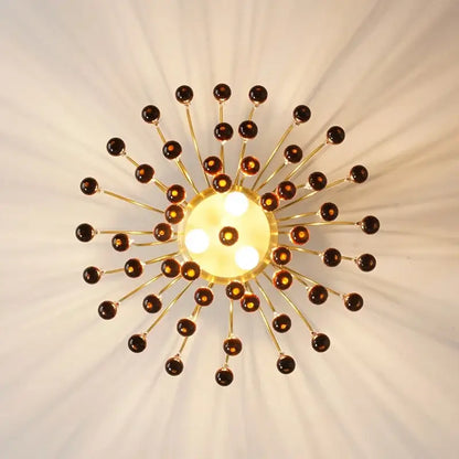Elegant crystal ceiling chandelier with golden sunburst design amber glass orbs and central illuminated panel for dining room decorbites elegant crystal