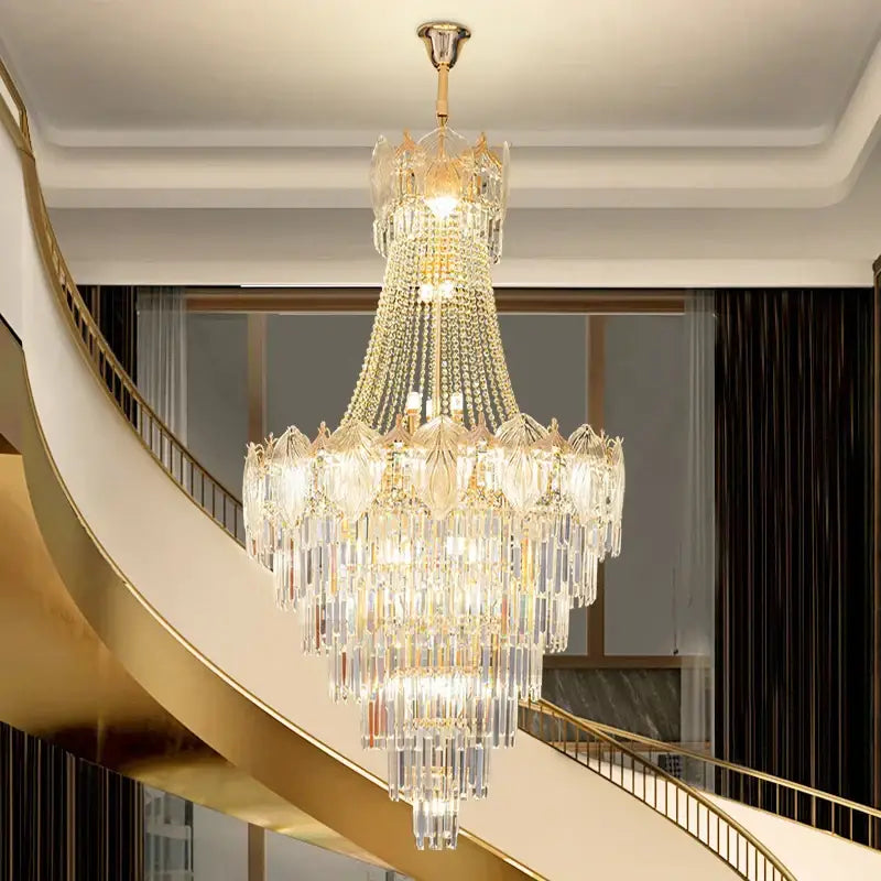 Elegant crystal duplex chandelier featuring cascading clear and gold-toned glass suspended from polished brass fixture