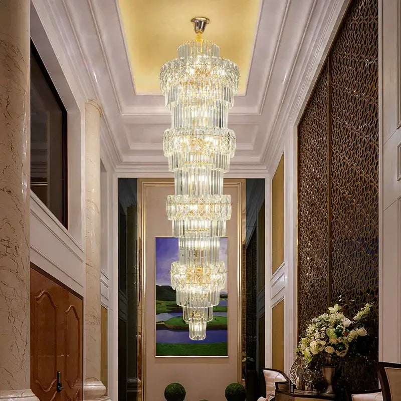 Elegant crystal hollow gold chandelier with cascading cylindrical glass elements and warm glowing lights for stairwell decorbites elegant crystal