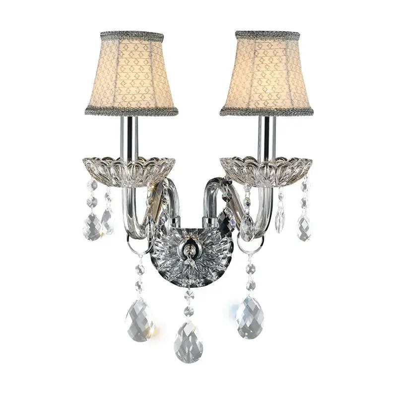 Elegant crystal lamp wall light with two arms, beige silk lampshades, and dangling clear faceted crystals for bedroom decorbites wall light