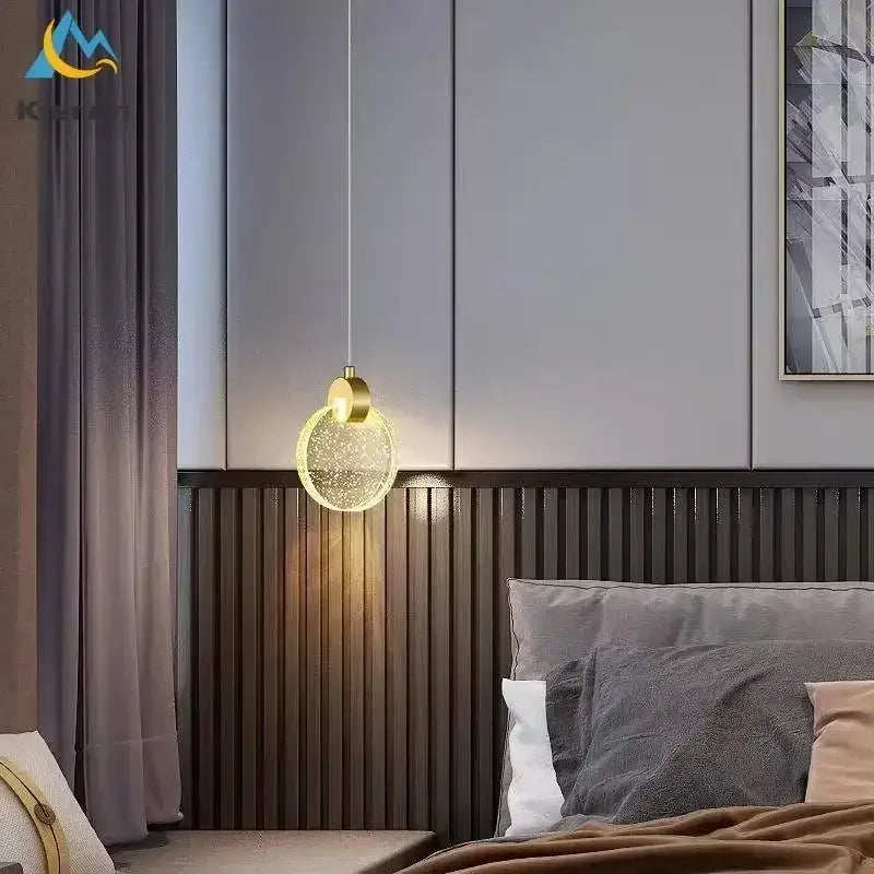 A decorbites elegant crystal led gold pendant light with spherical glass globe filled with sparkling particles above a bed