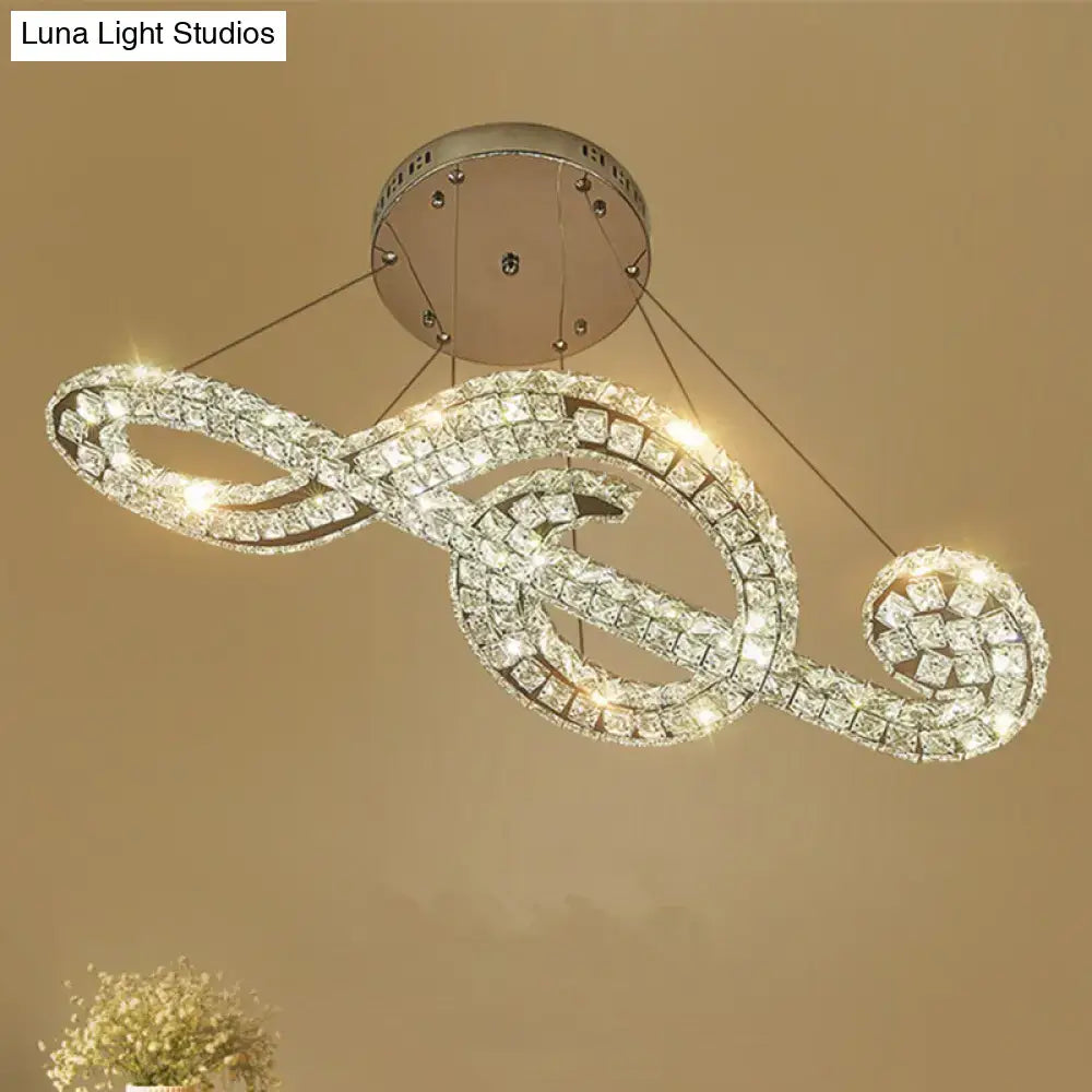 Decorbites™ musical note pendant light featuring a sparkling crystal treble clef design with white warm third leds