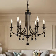Black wrought iron elegant crystal pendant chandelier with six candle-style bulbs and teardrop crystal pendants